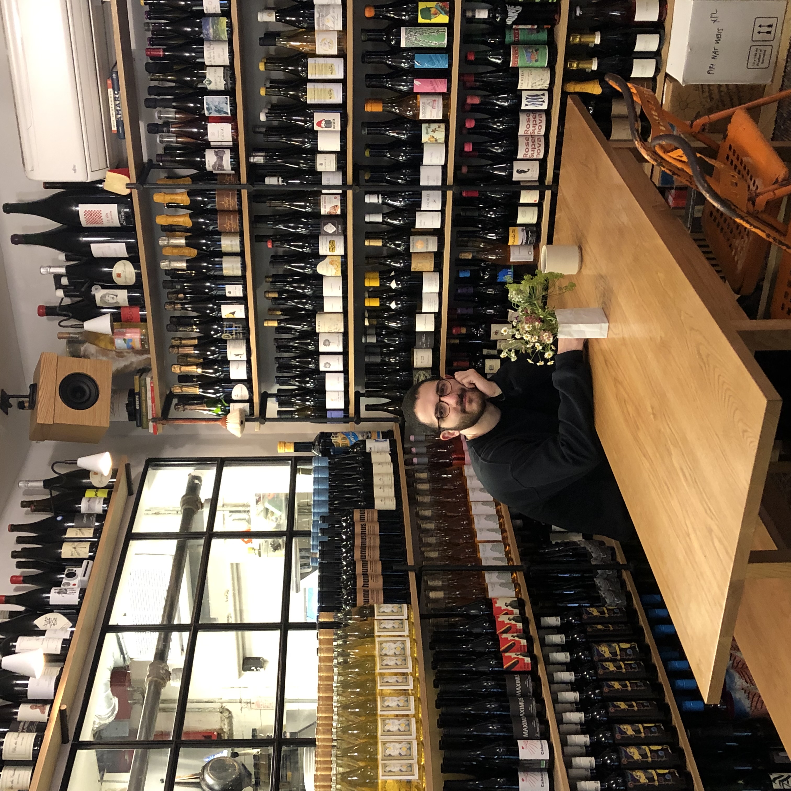 Picture of myself surrounded by wine bottles @ St Jardim, NYC.